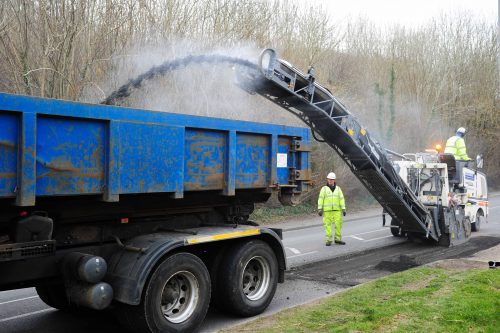 Road repairs: a 'plane and patch' team resurface a small section of road